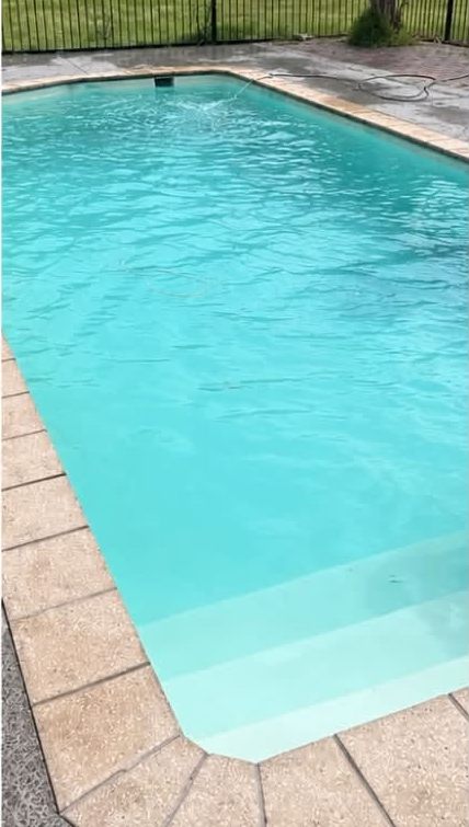 The same pool with clear blue water after treatment